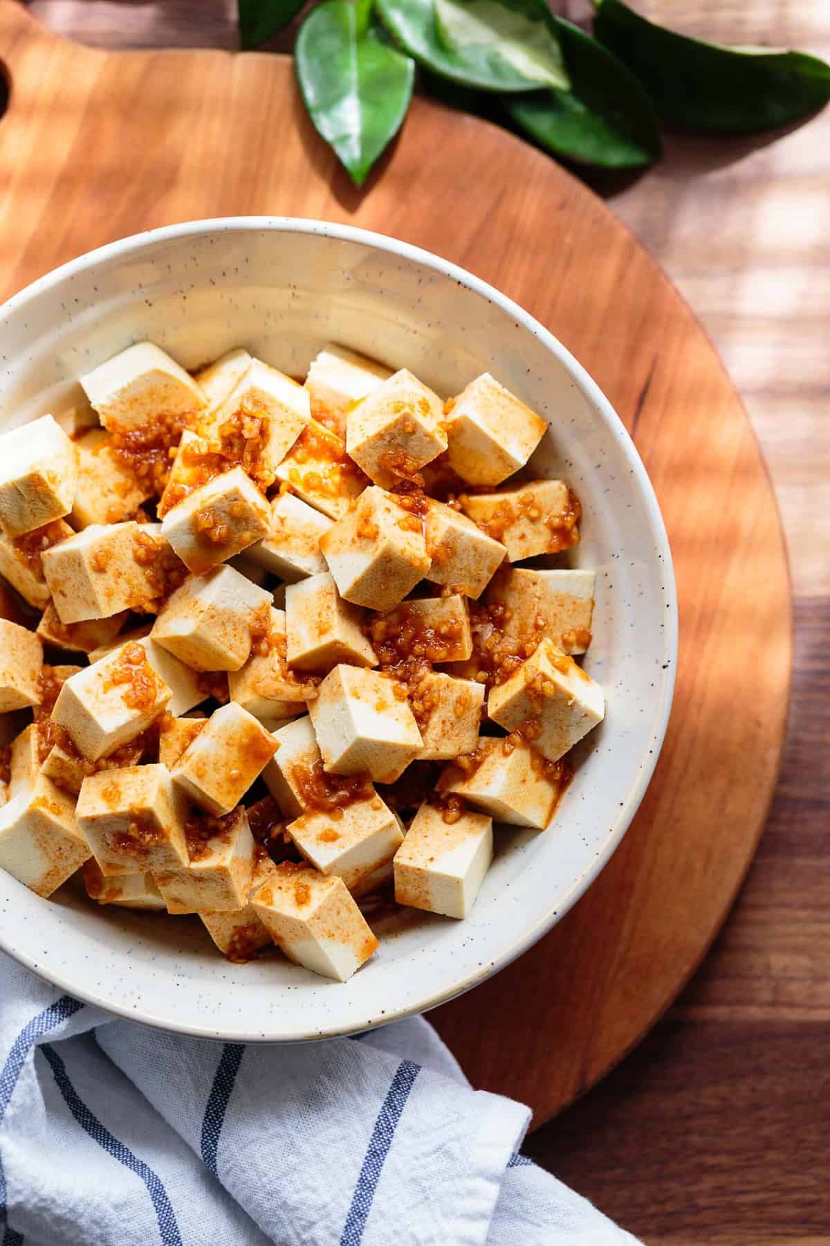 Extra-firm tofu cubes in a soy sauce, sriracha, sesame oil, and garlic marinade.
