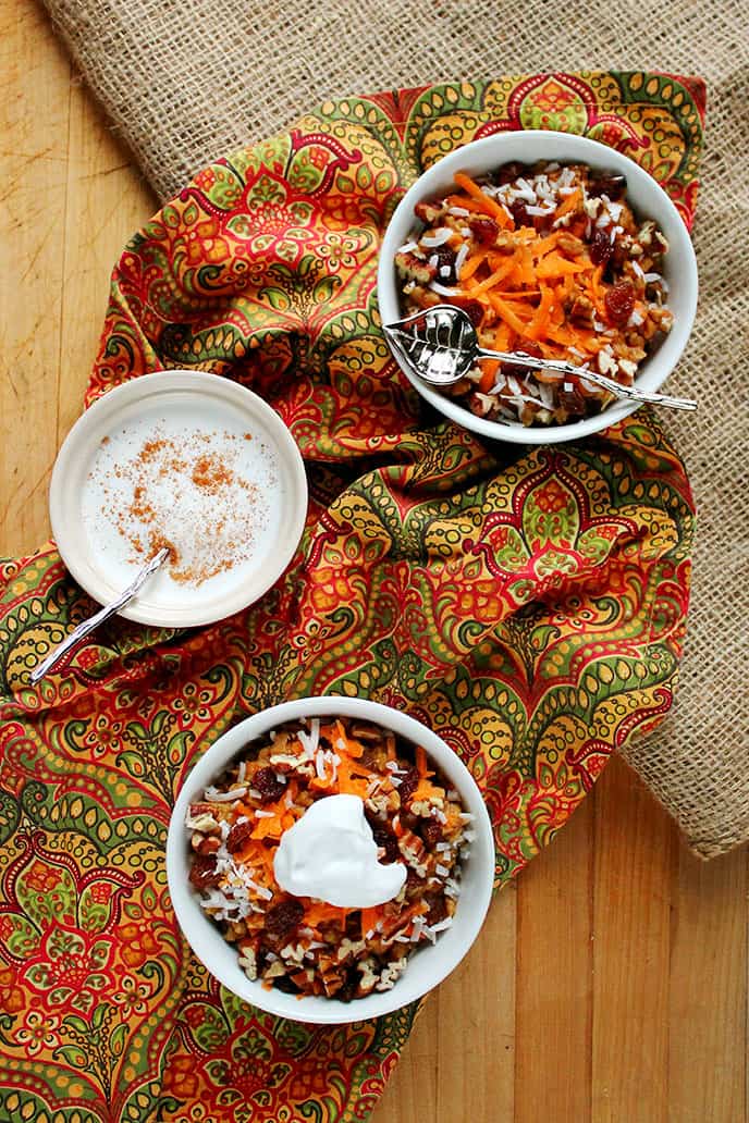 Spiced Carrot Cake Oatmeal with Coconut Cream {naturally sweetened!} via ilovevegan.com - A delectable dessert-worthy breakfast that's super simple and ready in under 15 minutes! Healthy eating staples are taken to a whole new level in this delicious breakfast. Think plump juicy raisins, crunchy pecans, flaked coconut, and traditional Fall spices like cinnamon and ginger - all naturally sweetened with soft caramel-y dates and real maple syrup. The perfect warming breakfast for a chilly Autumn morning! #vegan #glutenfree #soyfree #naturallysweetened #oatmeal