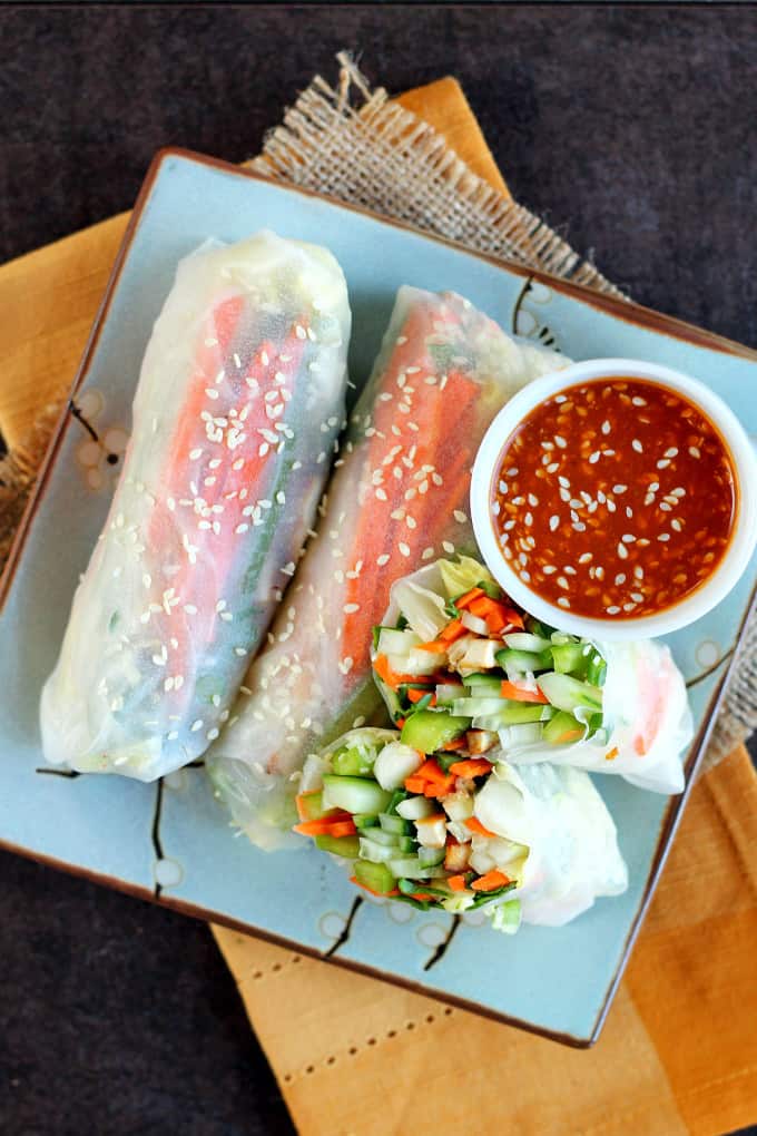 A plate of Vegan Rice Paper Rolls and sweet & spicy peanut dipping sauce.