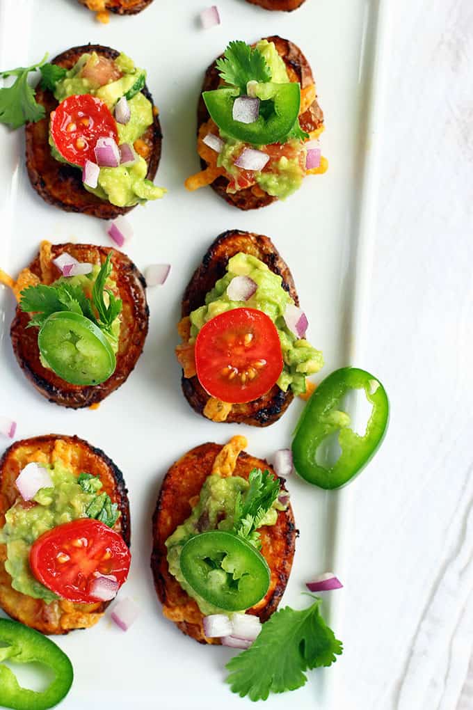 Spicy Nacho Potato Bites - ilovevegan.com - Crispy, spicy roasted potato medallions topped with melted vegan cheese, chunky homemade guacamole, and fresh vegetables. A perfect healthy spring and summer appetizer! #vegan #appetizer #Creamerpotatoes @LittlePotatoCo