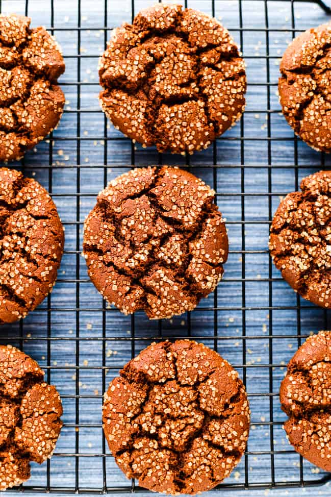Freshly baked vegan molasses cookies on a cooling rack.