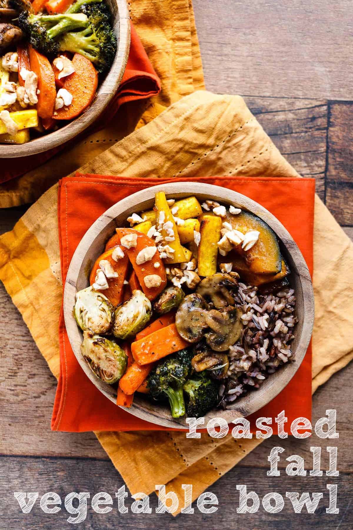 Two Roasted Fall Vegetable Bowls on a wood background.