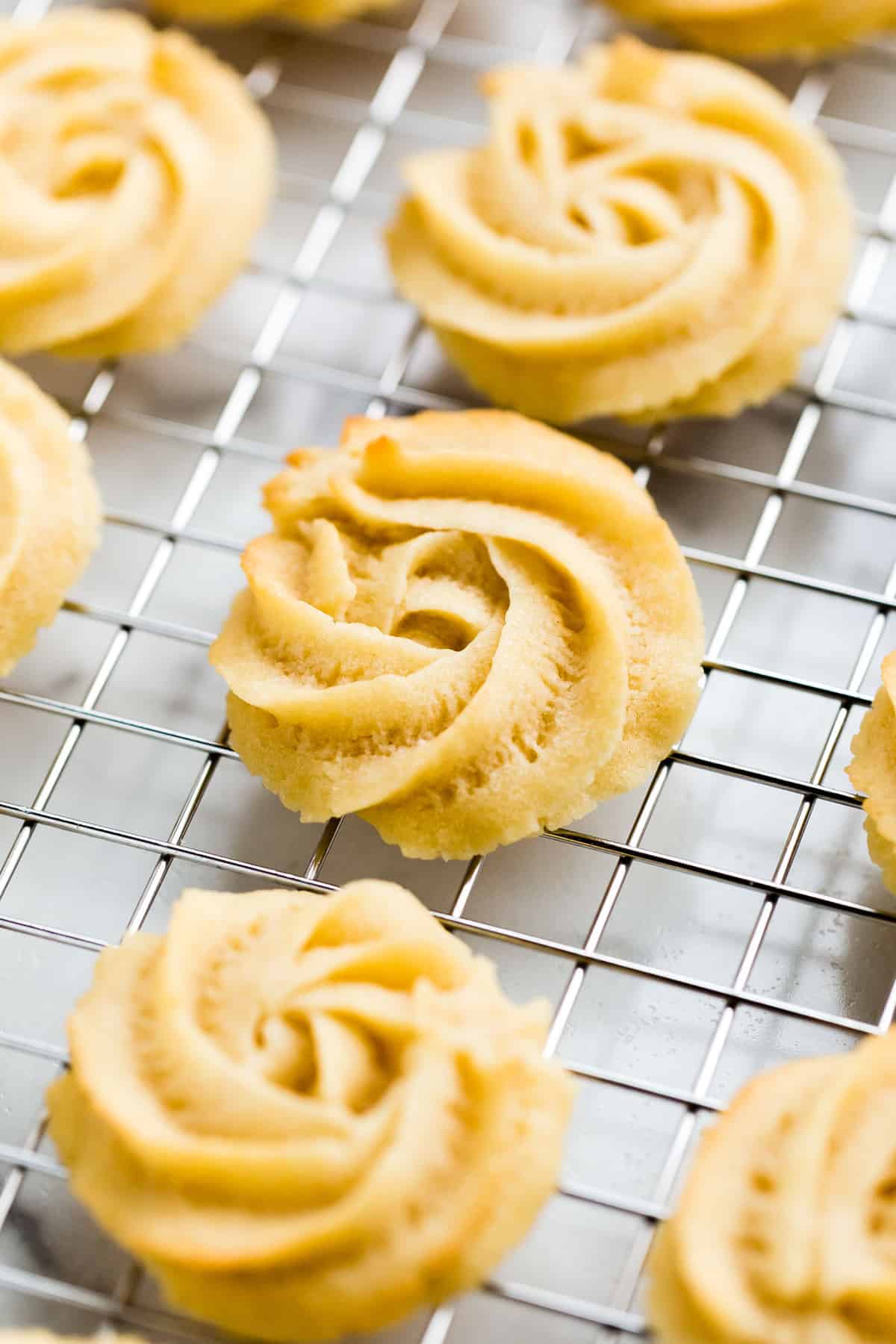 Vegan butter cookies cooling on a wire cooling rack/
