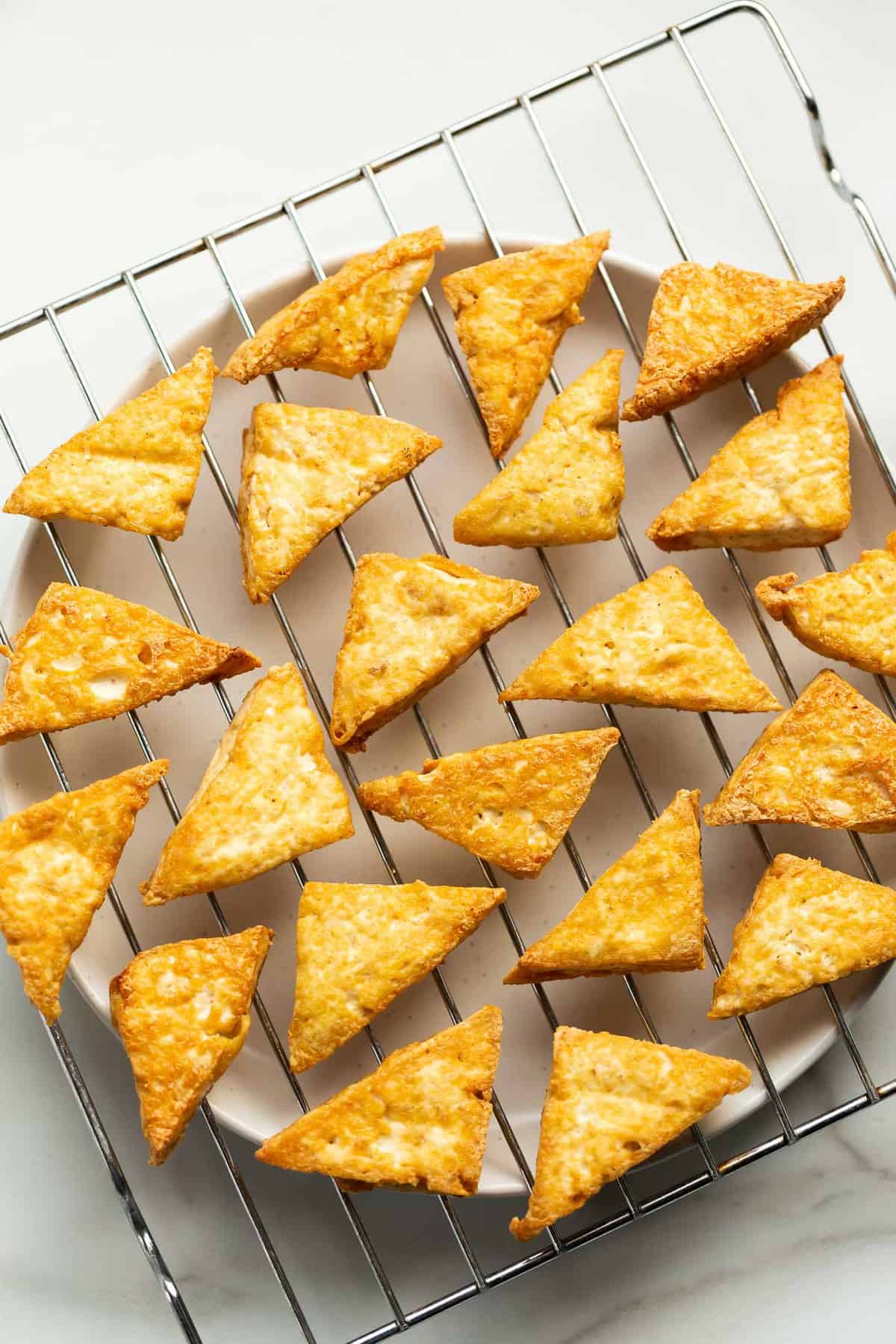 Triangles of fried, golden medium firm tofu.