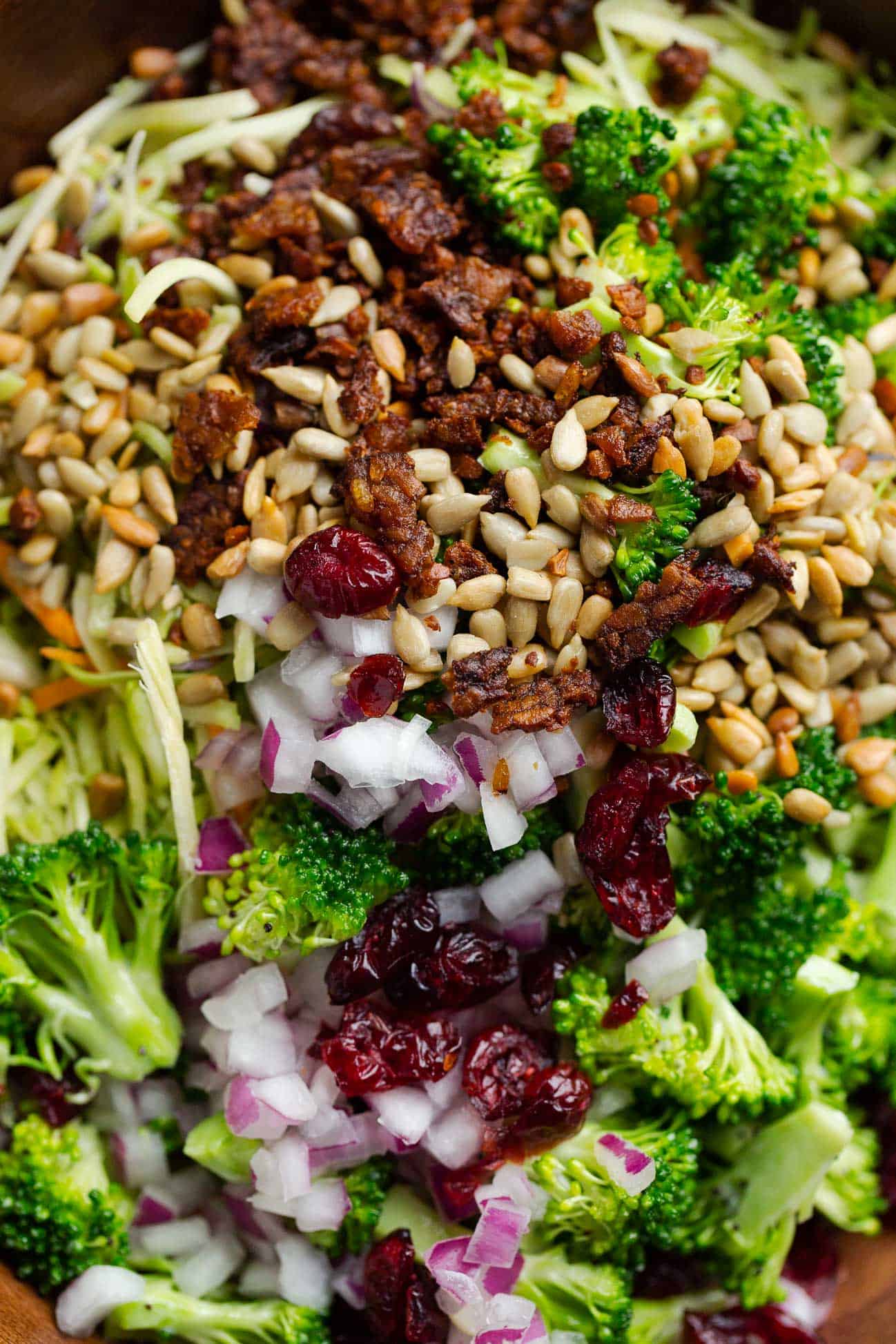 An unmixed bowl of ingredients to make vegan broccoli slaw salad.