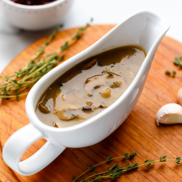 White porcelain gravy boat full of vegan mushroom gravy.