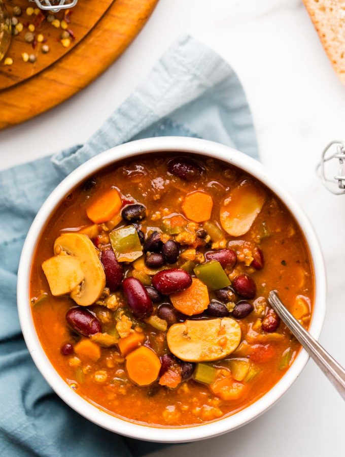 Overhead image of a bowl of vegan Instant Pot chili on a marble counter top.